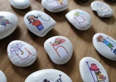 Hand-painted alphabet story stones used for early literacy play